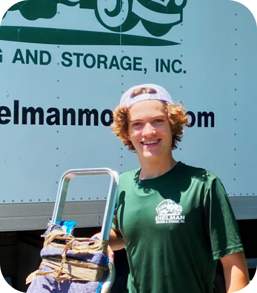 Charles Price, owner of Dielman Moving & Storage, in front of a Dielman truck