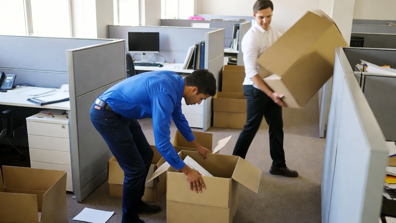 A Dielman crew packing and shrink-wrapping furniture inside a St. Louis home before a summer move